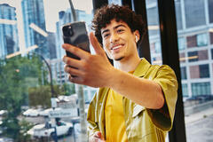 man smiling holding his phone
