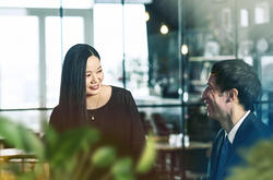 male and female talking and smiling.
