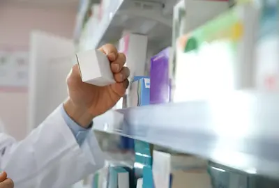 Close up of  a professional pharmacist with medicine in modern drugstore.