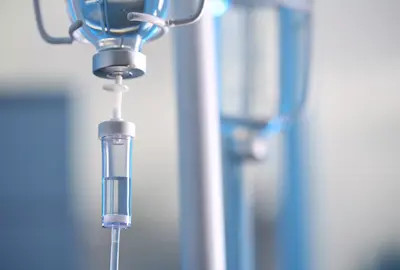 Close up of an IV drip against blurred background.