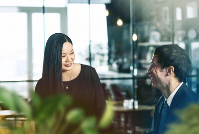 male and female talking and smiling.
