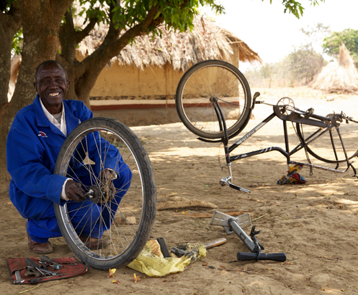 man repairing a bicycle