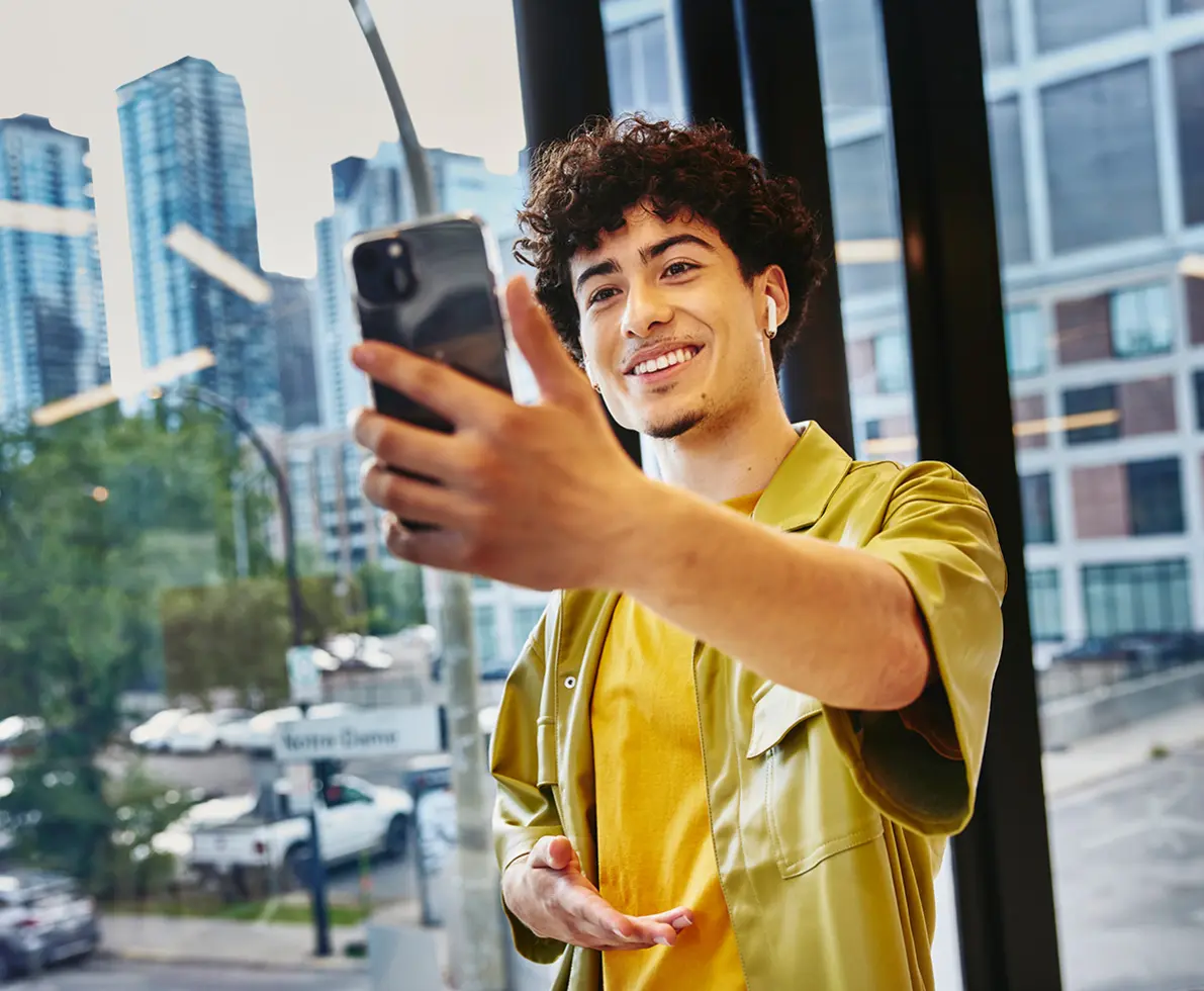 man smiling holding his phone