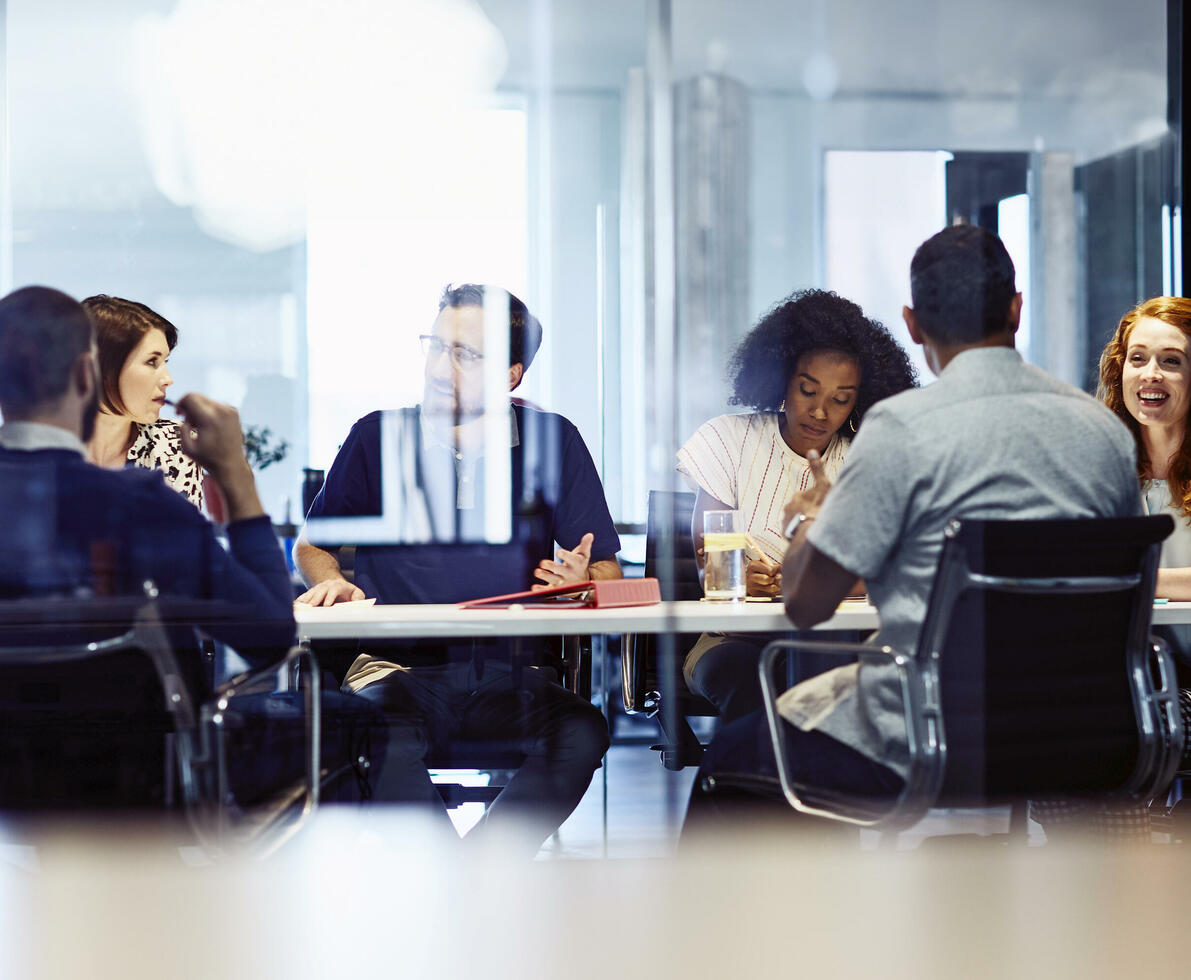 Group of colleagues sitting in a meeting room.
