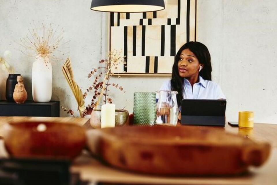 women working on tablet at the dinner table