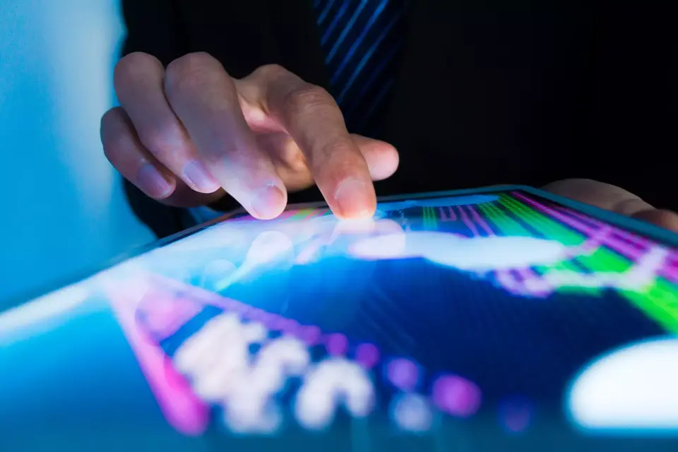 Market analyze with digital moniter focus on tip of finger