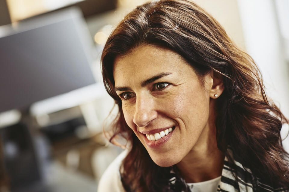 Close up - Smiling female looking away.
