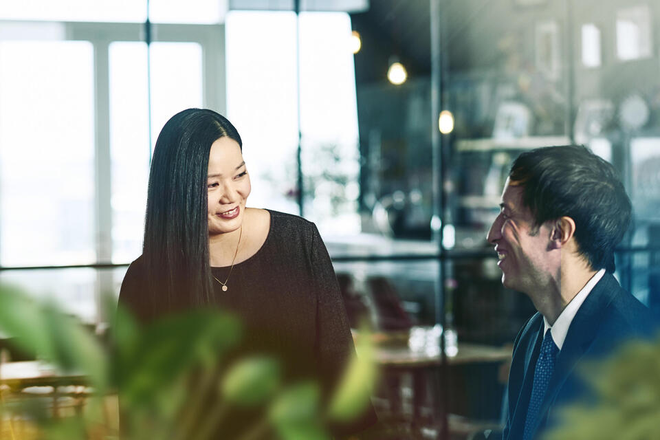 male and female talking and smiling.
